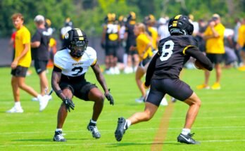 Josiah Trotter (left) jumps a pass to Jackson Daily (46) in practice