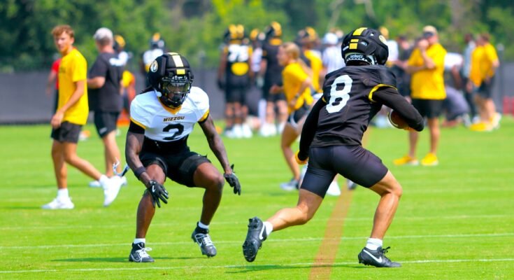 Josiah Trotter (left) jumps a pass to Jackson Daily (46) in practice