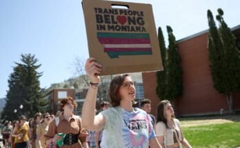 Los activistas de los derechos transgénero tienen señales mientras cruzan el campus de la Universidad de Montana el 03 de mayo de 2023 en Missoula, Mont.